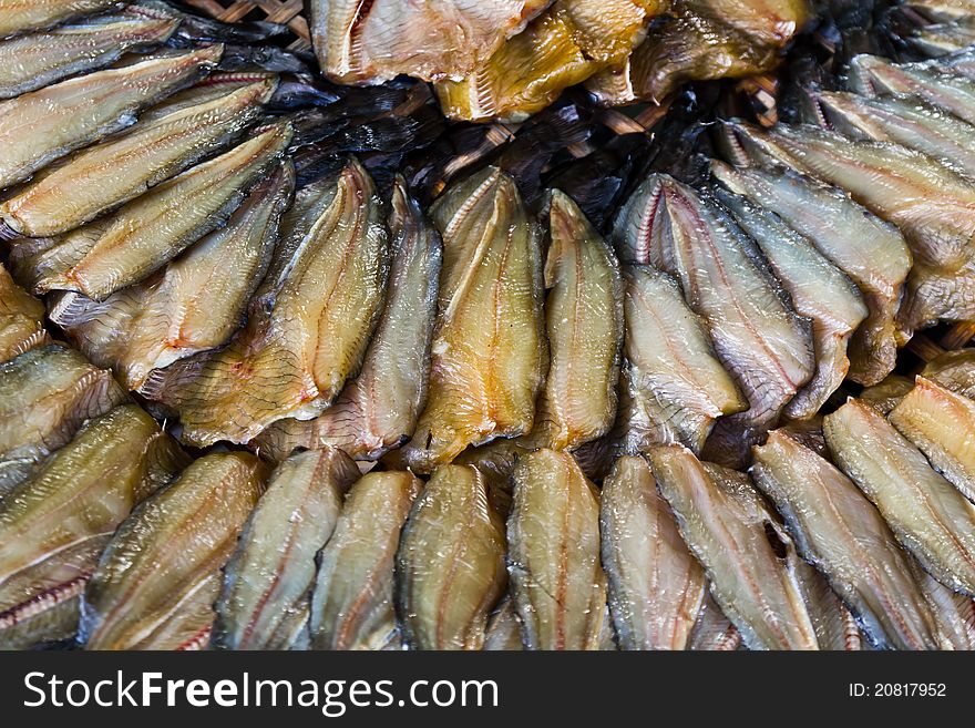 Dried fish in a circle on plate.