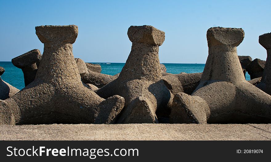 Storm protection structures at seashore, used to break large waves