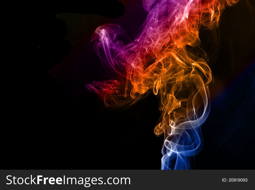 Colorful smoke abstract curly on black background