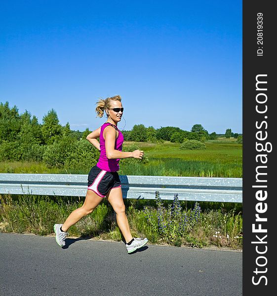 Happy woman running on country road. Happy woman running on country road