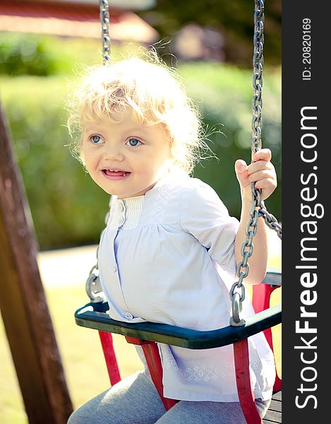 Little girl on a swing having a fun