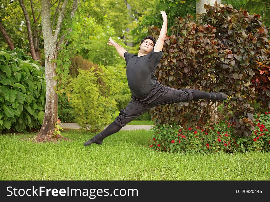 Male ballerina dancing in the park