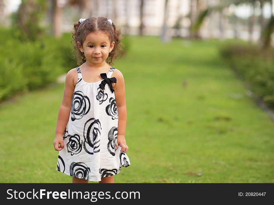 Image of an adorable little toddler in the park. Image of an adorable little toddler in the park