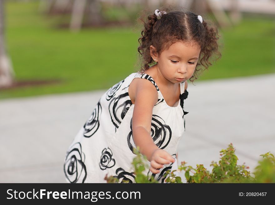 Image of a young child picking flowers in a garden