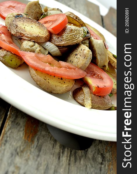 Fresh turkey sausage with potatoes and tomatoes ready for dinner. Fresh turkey sausage with potatoes and tomatoes ready for dinner.