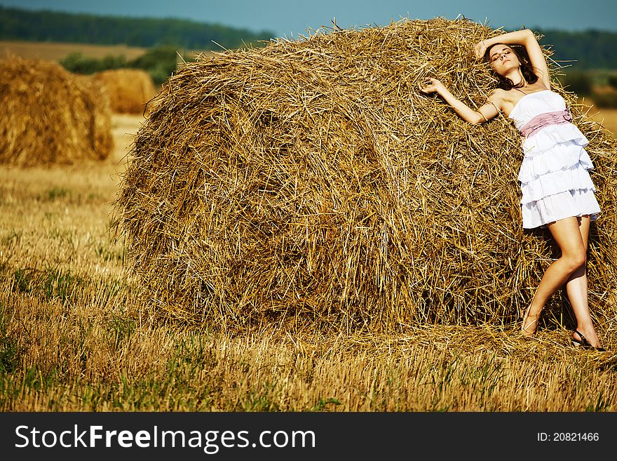 Beautiful girl enjoying the nature on fresh straw