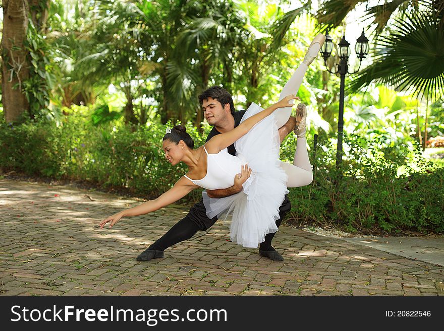 Couple performing ballet in the park