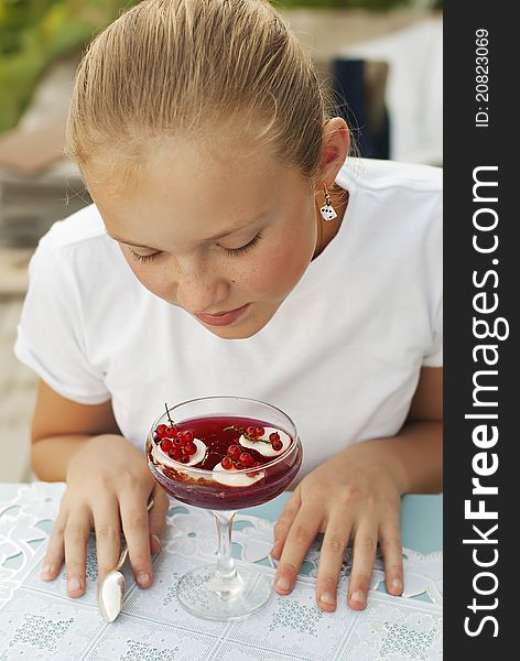 Girl eating red currant preserve. Girl eating red currant preserve