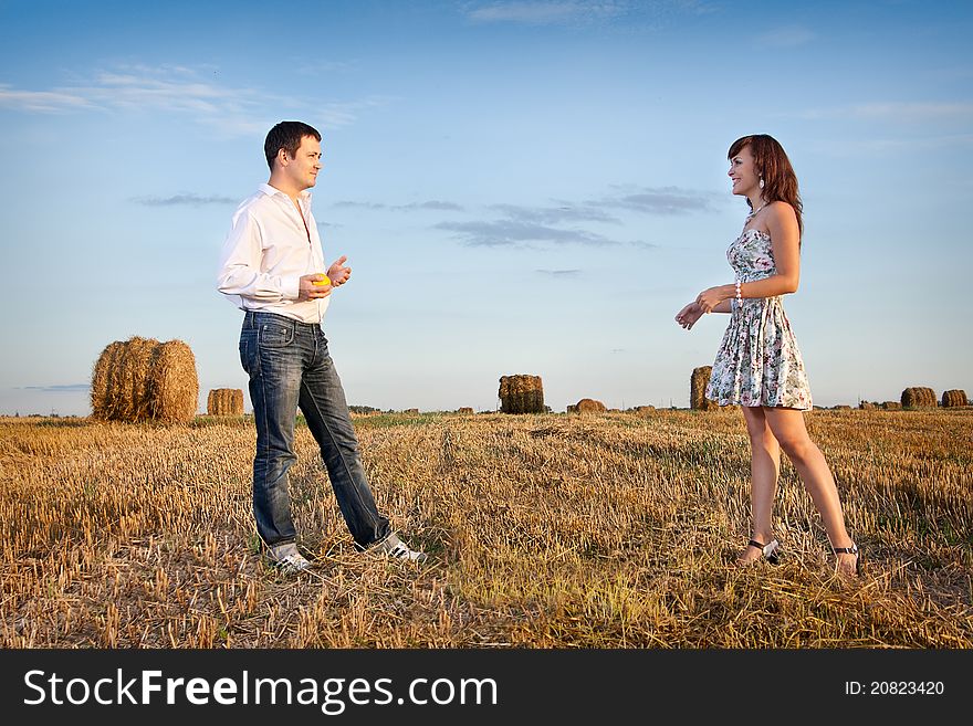 Married couple in the field nearby in solar weather