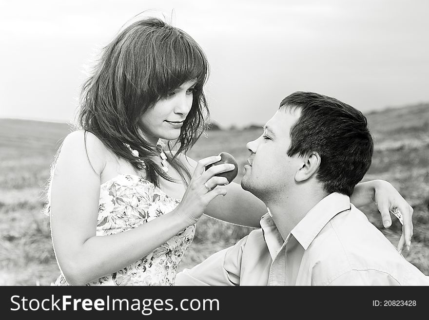 The wife feeds the husband in the field. The wife feeds the husband in the field