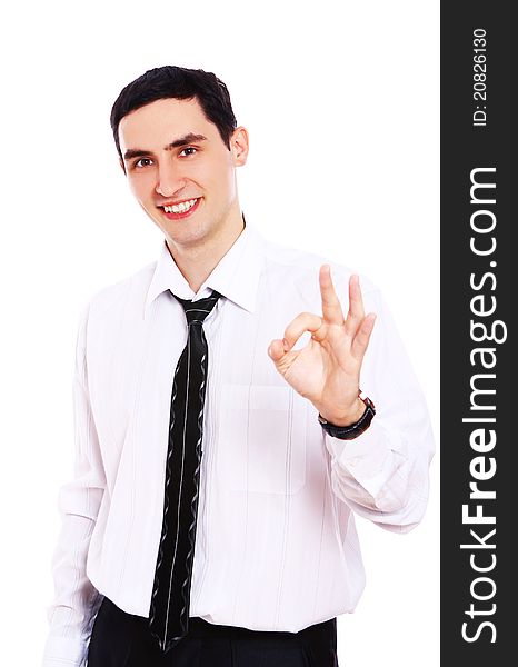 Young smiling businessman showing OK sign isolated over white