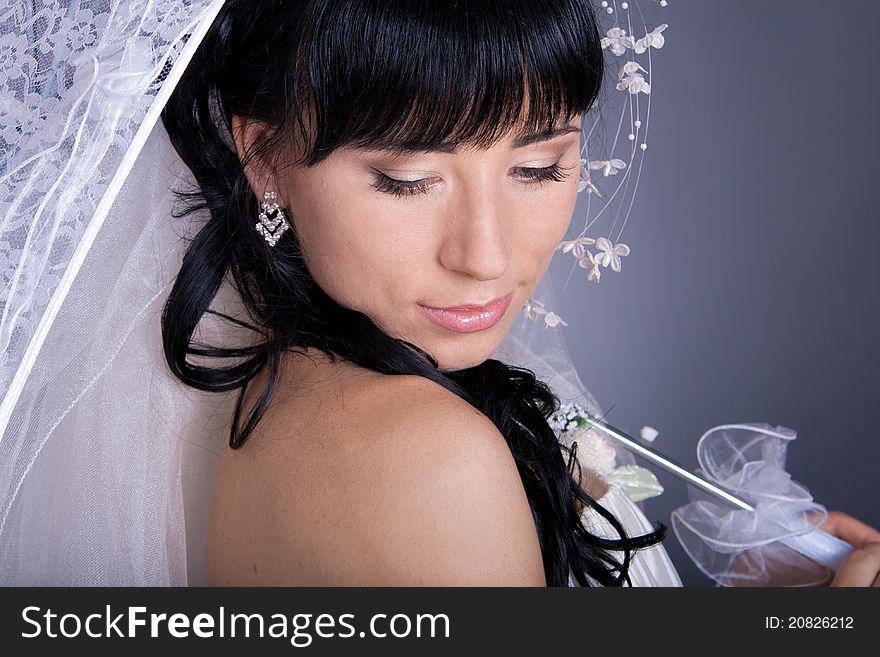 Romantic portrait of the bride's close-up, with an umbrella.