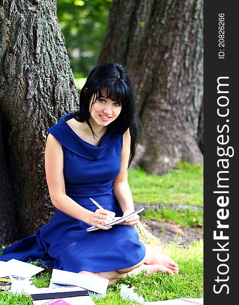 Beautiful girl studying in park