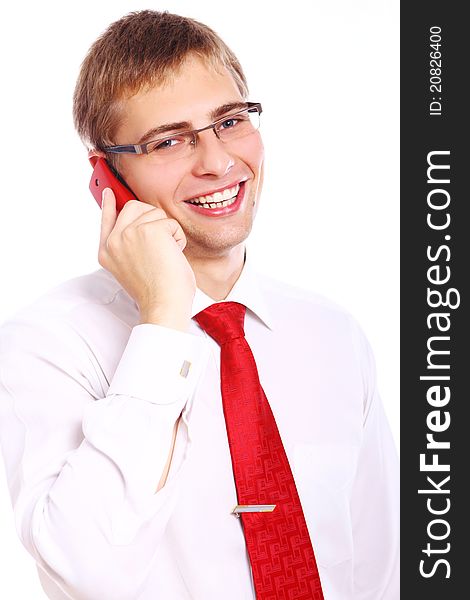 Young and successful businessman with smile uses cell phone. Young and successful businessman with smile uses cell phone