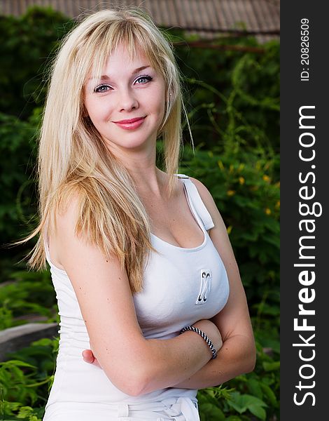 Young attractive blond girl posing outdoors