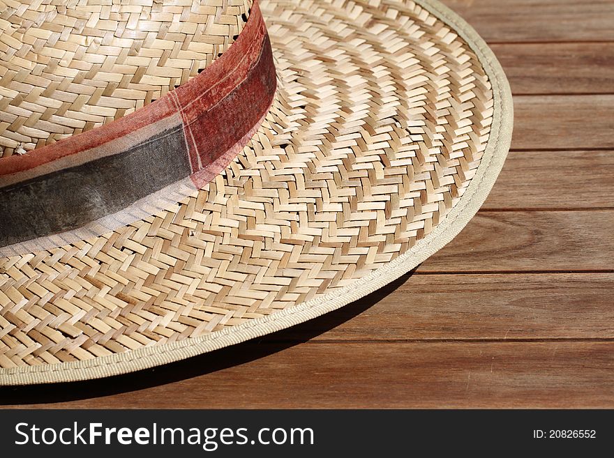 Details of a straw hat on a wooden table