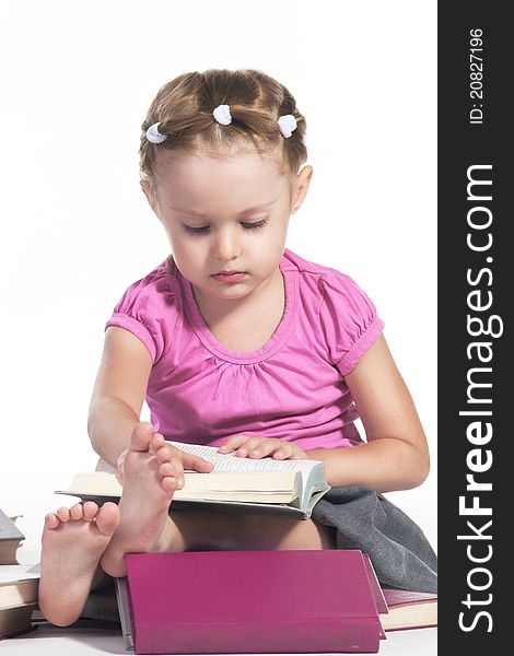 3 years girl sitting and reading a book. 3 years girl sitting and reading a book