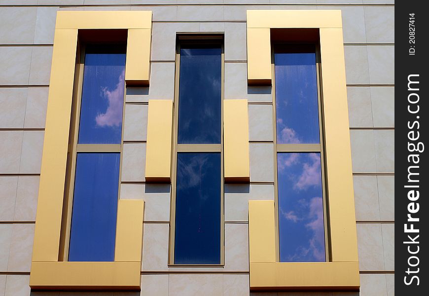 Architectural design of windows and reflection in them of the sky