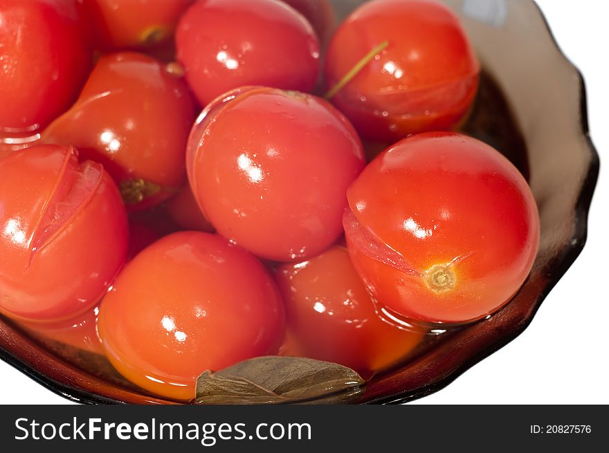 Marinated tomatoes in a glass vase