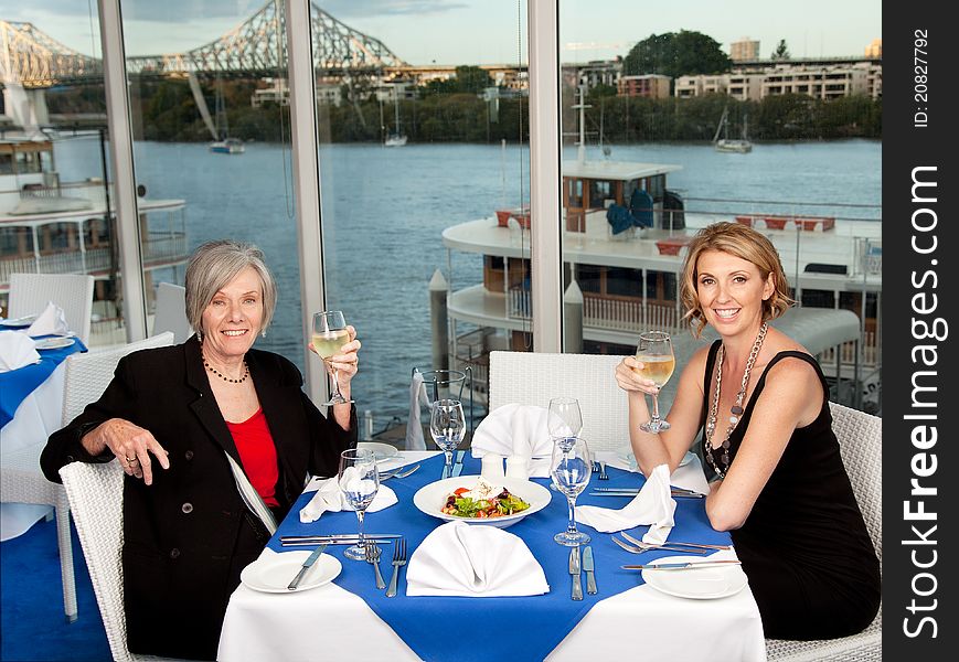 Two women enjoying a lunch with a view. Two women enjoying a lunch with a view