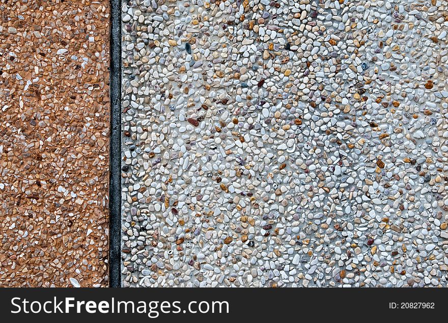 White gravel and concrete wall with vertical line, background texture.