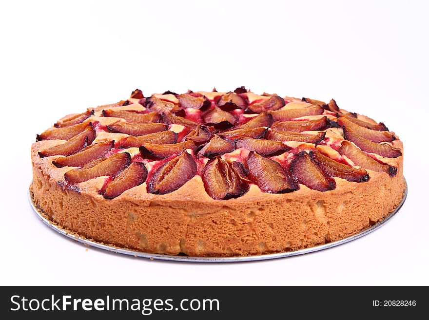 Plum pie on a white background