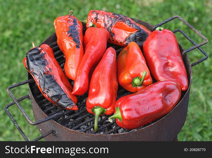 Red peppers being grilled over an outdoor barbeque. Red peppers being grilled over an outdoor barbeque