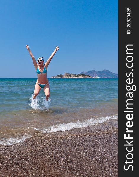 Beautiful young woman having fun on the beach. Beautiful young woman having fun on the beach