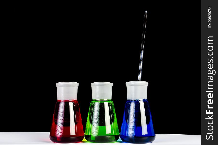 3 colors chemicals in laboratory glassware. 3 colors chemicals in laboratory glassware