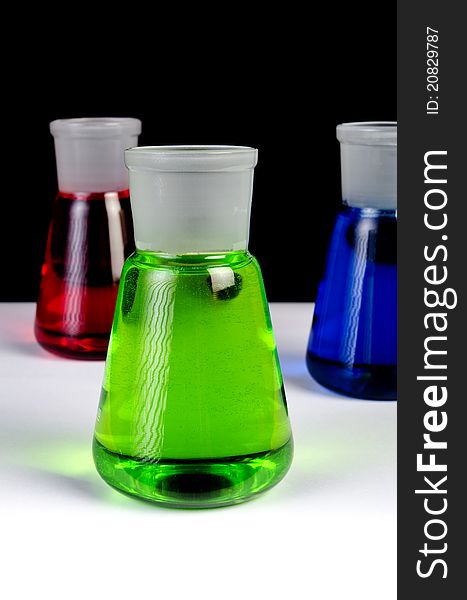 Chemicals In Laboratory Glassware On Black