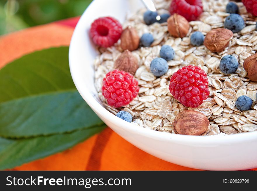 Oat nuts with fresh blueberries and raspberries and hazelnuts. Oat nuts with fresh blueberries and raspberries and hazelnuts