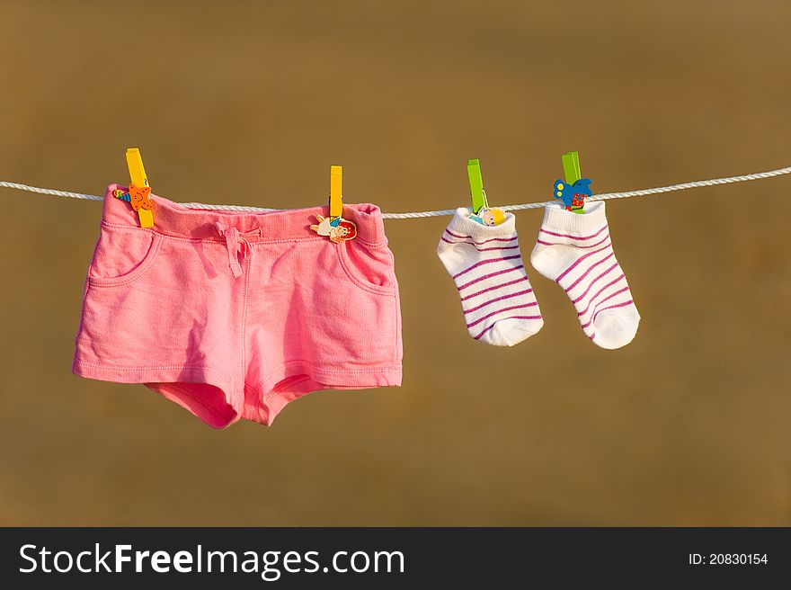Child clothes are drying on a line. Child clothes are drying on a line