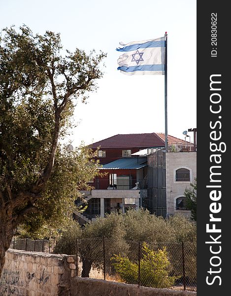 A ragged Israeli flag flies over the Jewish settlement of Beit Hoshen on the Mount of Olives in East Jerusalem.