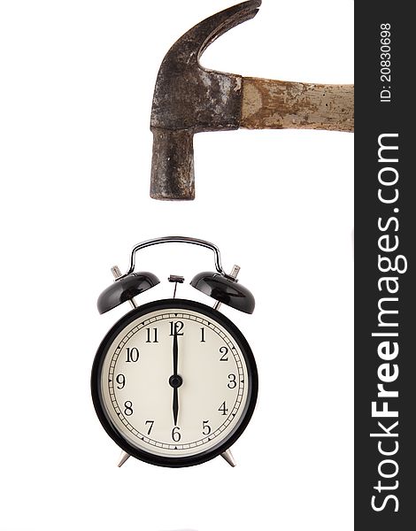 Hammer about to smash alarm clock, white background.