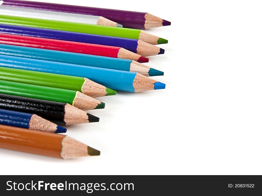 Color pencils in arrange in color wheel colors on white background with copy space