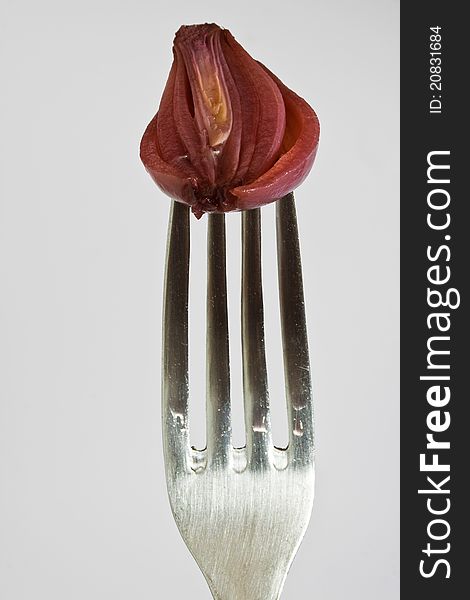 Closeup of red onion on fork