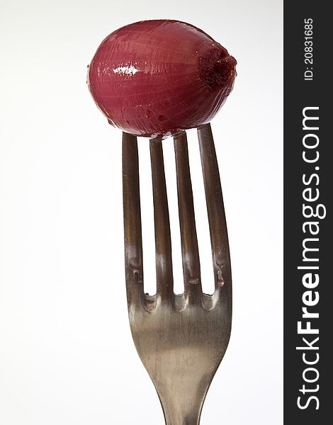 Closeup of red onion on fork