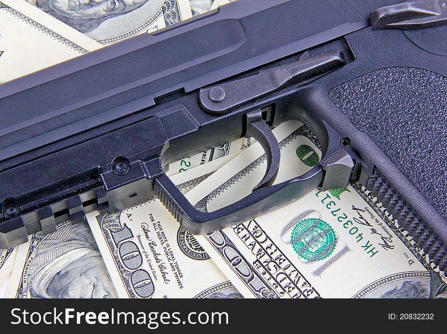 Black automatic Handgun on dollar notes
