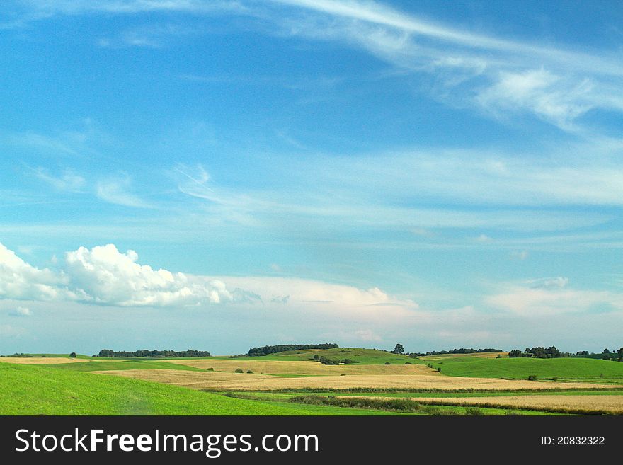 Green meadow sweat dark clouds