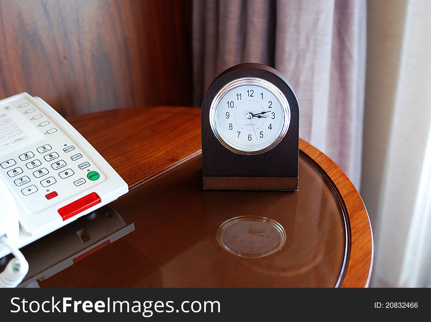 A corner in bedroom :alarm clock and telephone. A corner in bedroom :alarm clock and telephone