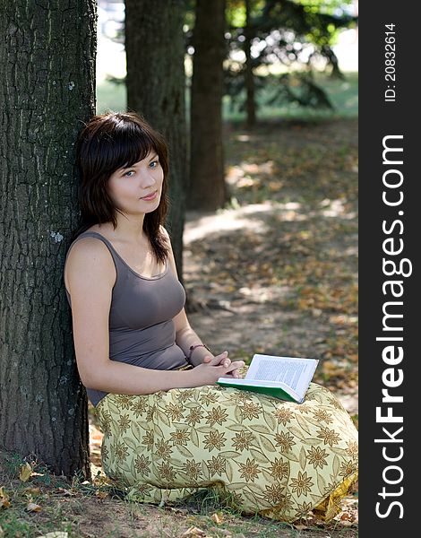 Girl reading book in park