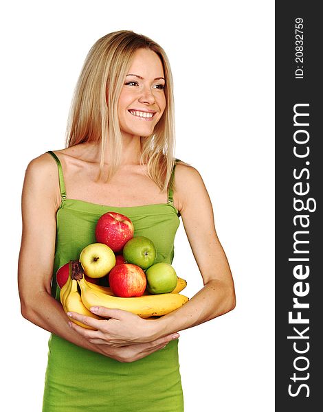 Woman holds a pile of fruit on a white background