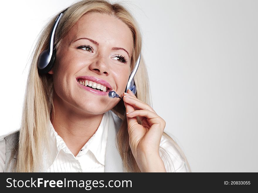 Business woman in a headset on a gray background