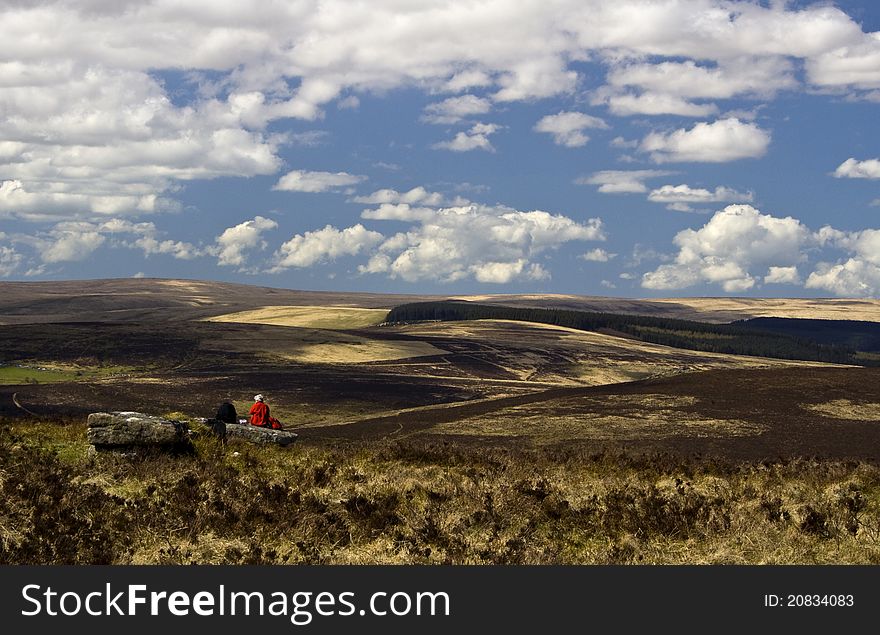 Walkers Enjoying A View Across Dartmoor