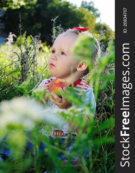 Baby With Peach On The Meadow