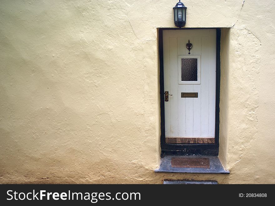 A rendered wall with a white door.