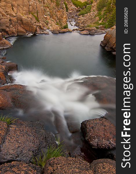 Pretty alpine waterfall in Northern California with motion blurred water cascade into calm pool. Pretty alpine waterfall in Northern California with motion blurred water cascade into calm pool