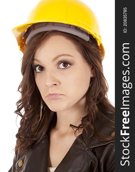 A close up of a woman in her construction hat with a sad expression on her face. A close up of a woman in her construction hat with a sad expression on her face.