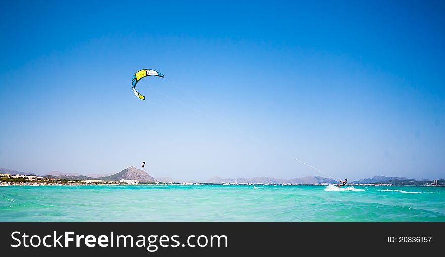 A kitesurfer on a beautiful beach in Spain. A kitesurfer on a beautiful beach in Spain