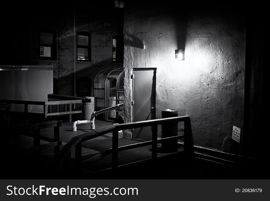 Dark black and white image of a building roof deck at night in boston. Dark black and white image of a building roof deck at night in boston.